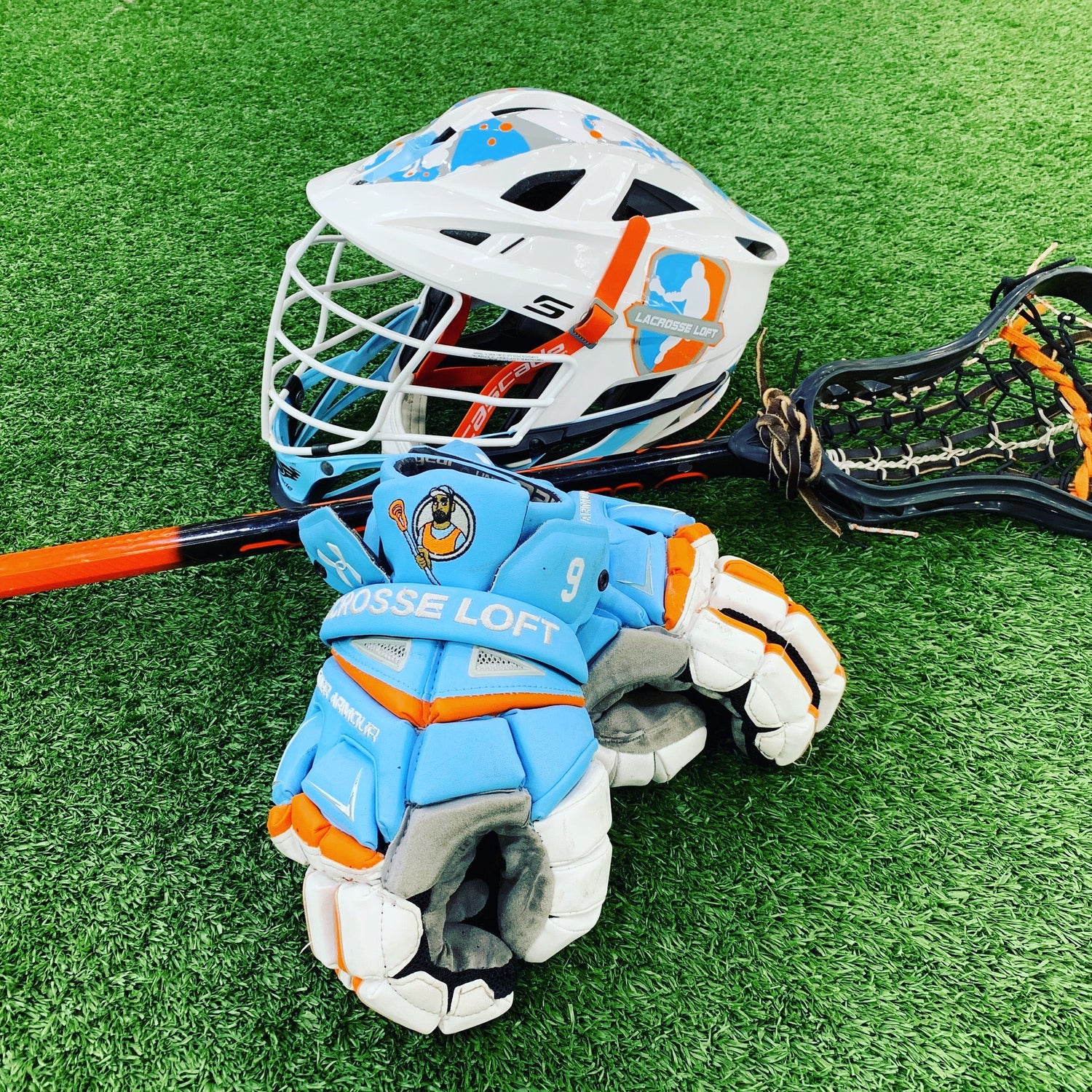 A lacrosse helmet, lacrosse gloves, and lacrosse shafts.