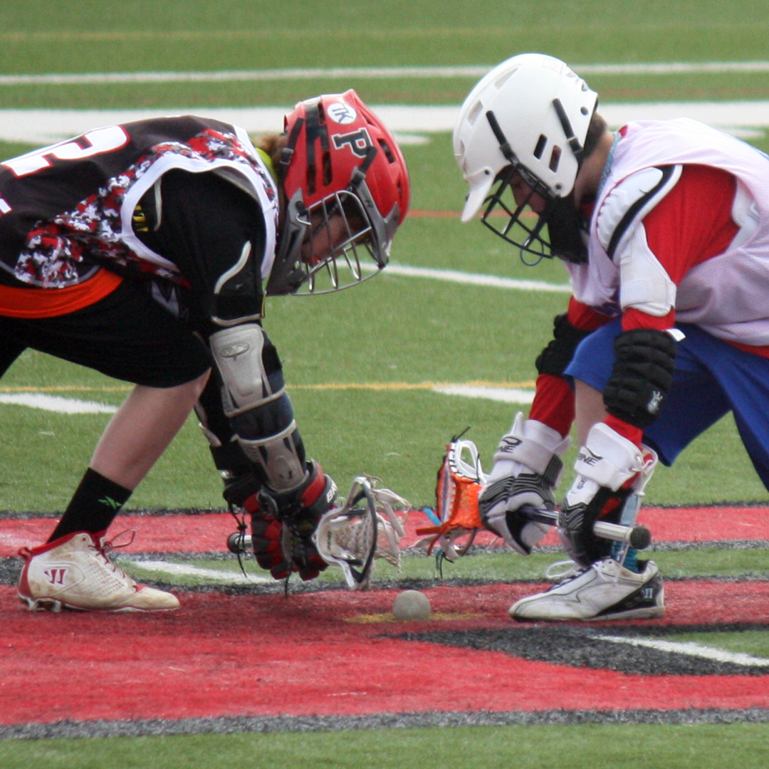 Two athletes playing a game of lacrosse using boys lacrosse gear.